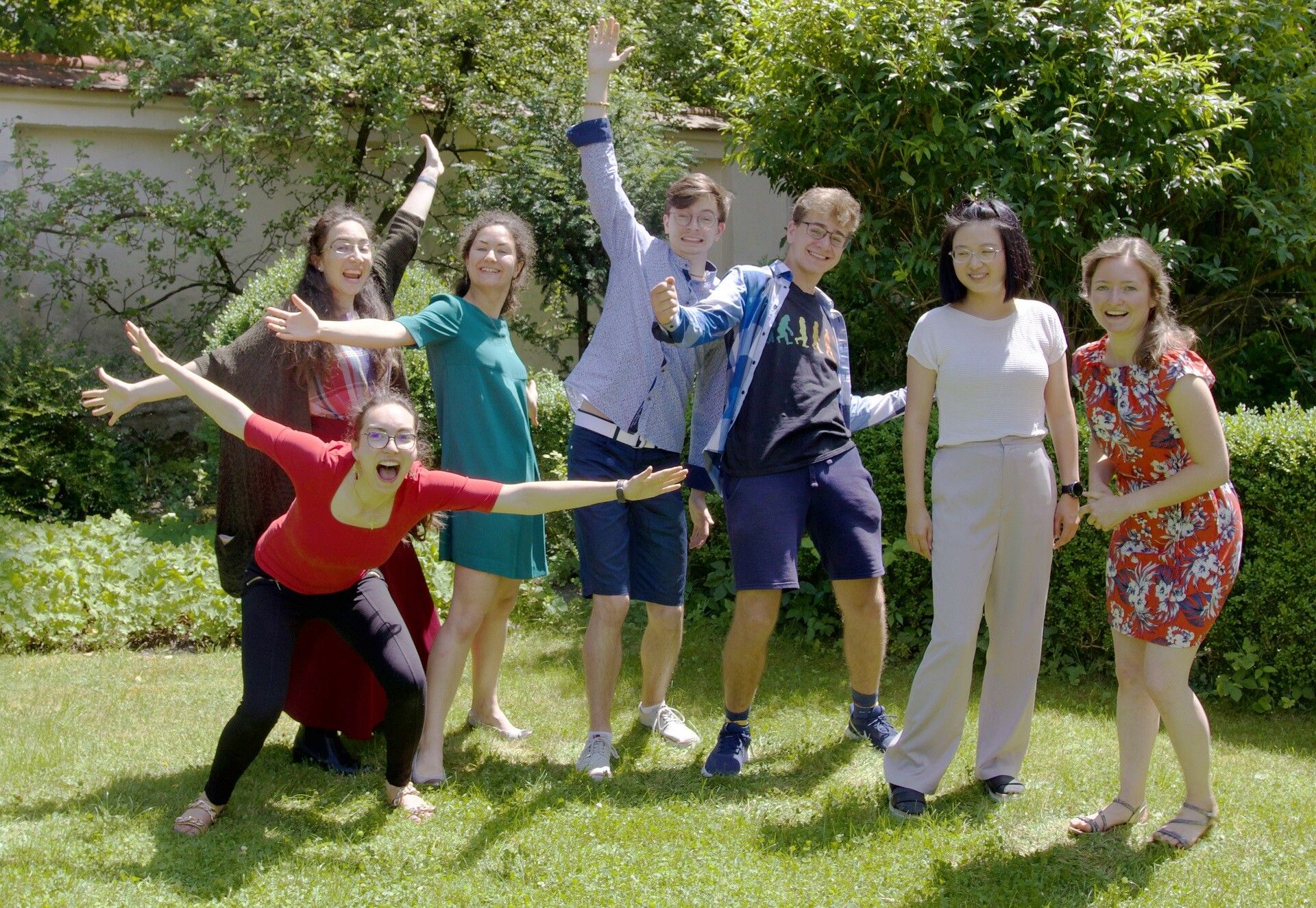Missionaries striking joyful poses in the Josefsburg garden